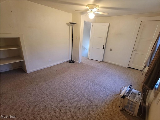 9788 E River Rd, Elyria, OH 44035 - unfurnished bedroom with carpet floors, baseboards, a ceiling fan, and an AC wall unit
