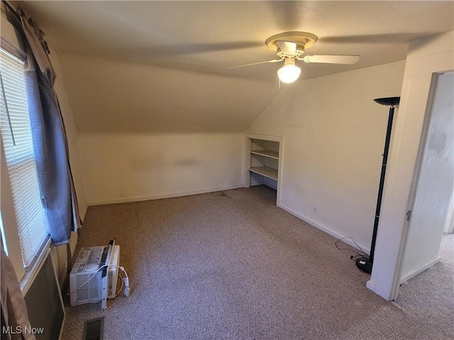 9788 E River Rd, Elyria, OH 44035 - additional living space featuring carpet flooring, ceiling fan, vaulted ceiling, baseboards, and a wall mounted air conditioner