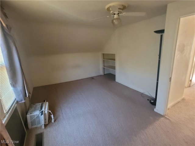 9788 E River Rd, Elyria, OH 44035 - additional living space featuring carpet floors, ceiling fan, lofted ceiling, and a wall unit AC