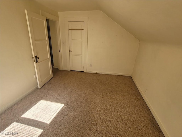 9788 E River Rd, Elyria, OH 44035 - additional living space featuring carpet floors, vaulted ceiling, and baseboards
