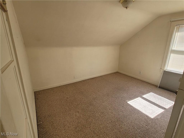 9788 E River Rd, Elyria, OH 44035 - bonus room with lofted ceiling, light carpet, and baseboards