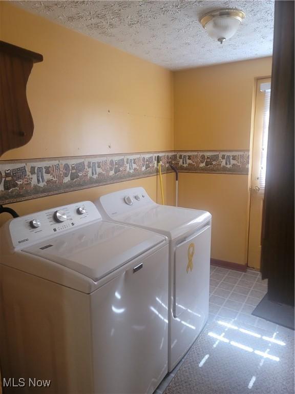 9788 E River Rd, Elyria, OH 44035 - washroom with separate washer and dryer and a textured ceiling