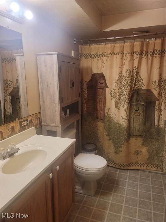 9788 E River Rd, Elyria, OH 44035 - bathroom with toilet, vanity, and a shower with shower curtain