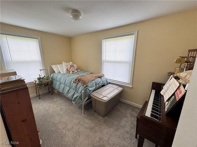 bedroom with multiple windows, carpet floors, and baseboards