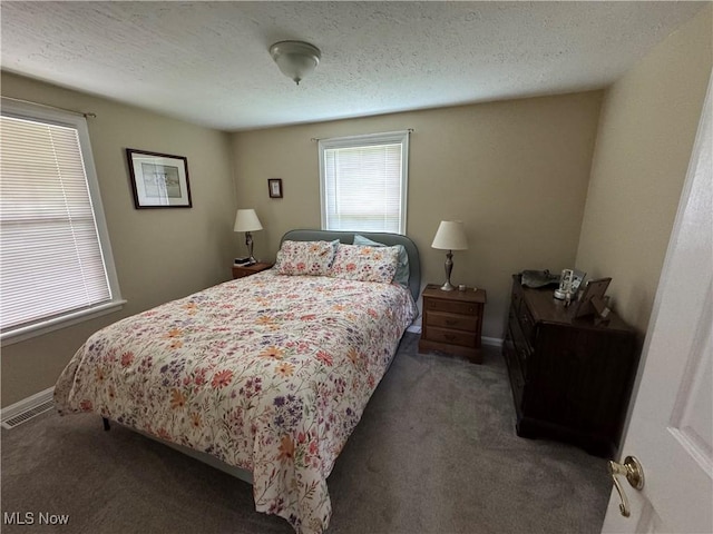 bedroom featuring carpet, a textured ceiling, and baseboards
