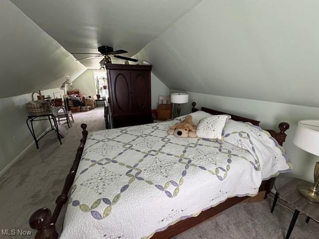 carpeted bedroom featuring vaulted ceiling and ceiling fan
