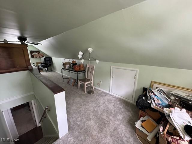 additional living space featuring lofted ceiling and carpet floors
