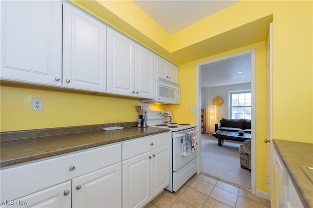 13710 Shaker Blvd Unit 405, Cleveland, OH 44120 - kitchen featuring white appliances, white cabinetry, light colored carpet, dark countertops, and light tile patterned flooring