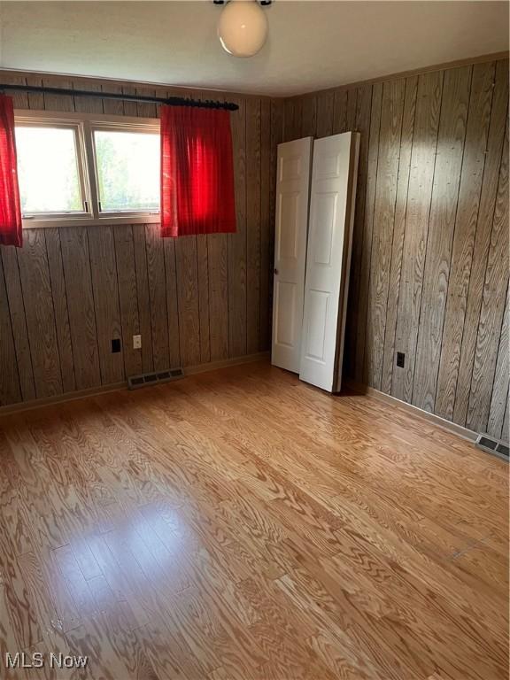 2840 Brian Dr, Parma, OH 44134 - unfurnished bedroom with wood finished floors and wooden walls