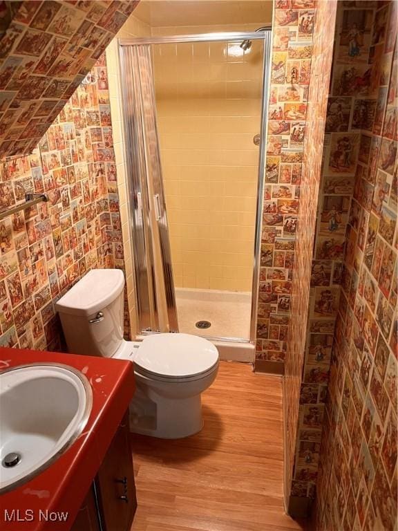 2840 Brian Dr, Parma, OH 44134 - bathroom with wood finished floors, a stall shower, toilet, and vanity