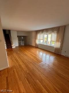 2840 Brian Dr, Parma, OH 44134 - unfurnished living room featuring wood finished floors