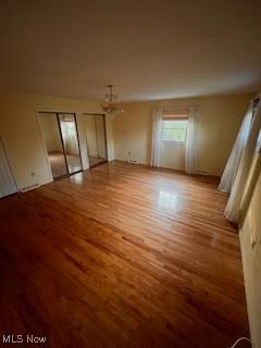 2840 Brian Dr, Parma, OH 44134 - spare room featuring wood finished floors and a chandelier