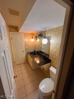 2840 Brian Dr, Parma, OH 44134 - bathroom with wallpapered walls, tile patterned floors, and toilet