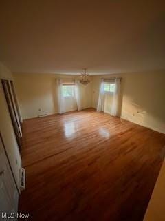2840 Brian Dr, Parma, OH 44134 - spare room featuring wood finished floors and a chandelier