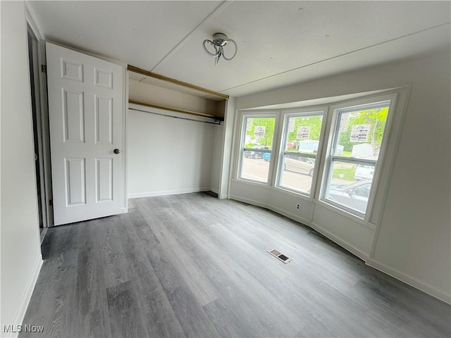 11 Redwood Dr, Beloit, OH 44609 - unfurnished bedroom with wood finished floors, baseboards, and a closet