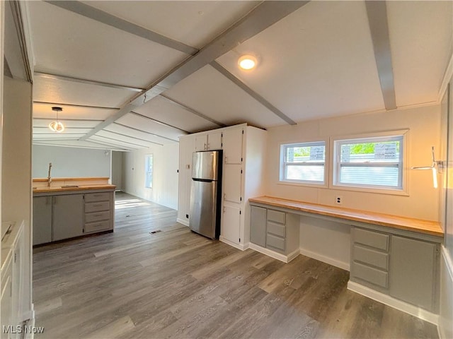 11 Redwood Dr, Beloit, OH 44609 - kitchen with freestanding refrigerator, white cabinets, wood finished floors, baseboards, and a sink