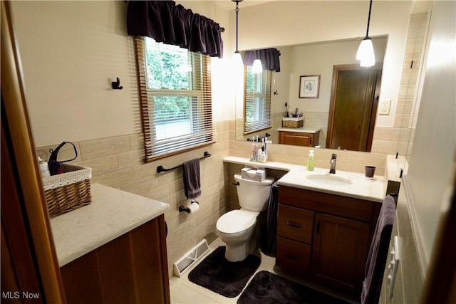 2724 Spitler Rd, Poland, OH 44514 - bathroom featuring toilet, vanity, tile walls, and backsplash
