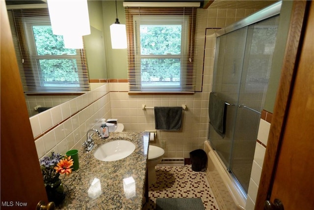 2724 Spitler Rd, Poland, OH 44514 - bathroom featuring tile walls, toilet, vanity, and combined bath / shower with glass door