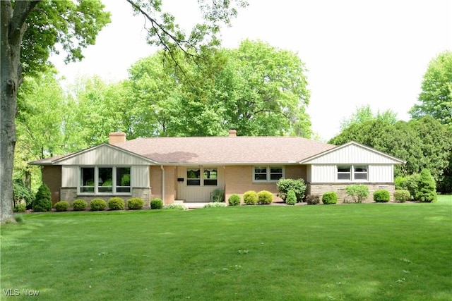 2724 Spitler Rd, Poland, OH 44514 - ranch-style house featuring a chimney, a front lawn, stone siding, and board and batten siding