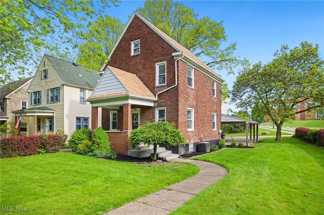397 N Firestone Blvd, Akron, OH 44301 - view of front of home featuring brick siding, a front lawn, and central air condition unit
