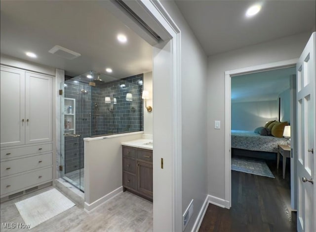 22099 Shaker Blvd, Shaker Heights, OH 44122 - ensuite bathroom with wood finished floors, a stall shower, vanity, baseboards, and recessed lighting