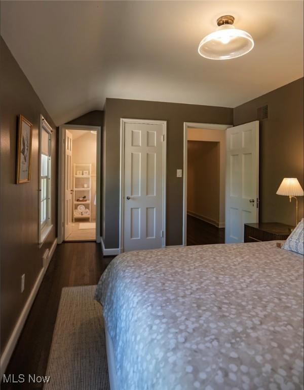 22099 Shaker Blvd, Shaker Heights, OH 44122 - bedroom with dark wood-style flooring, vaulted ceiling, and baseboards