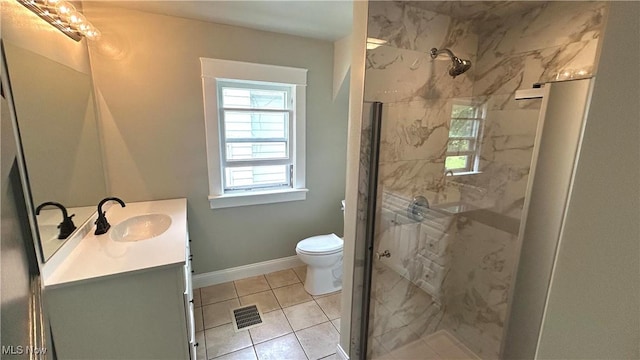 full bath featuring a marble finish shower, vanity, tile patterned flooring, toilet, and baseboards