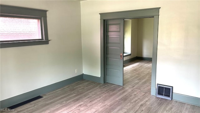 empty room featuring wood finished floors and baseboards