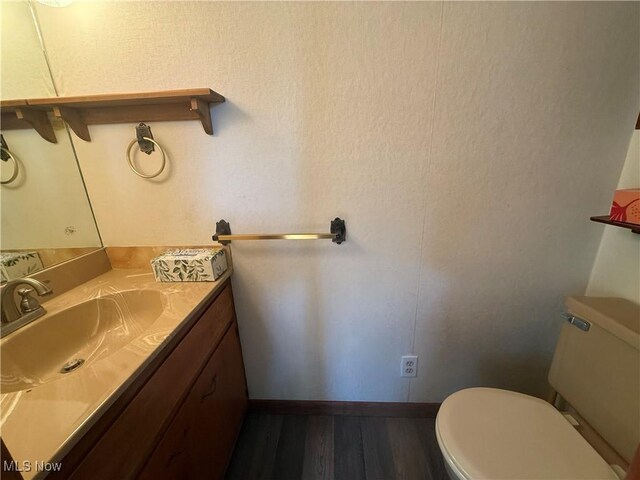 1707 Clairmont Ave, Cambridge, OH 43725 - bathroom with toilet, wood finished floors, vanity, and baseboards