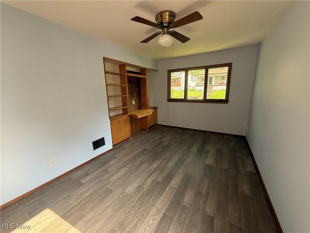 1707 Clairmont Ave, Cambridge, OH 43725 - unfurnished living room with dark wood-type flooring, ceiling fan, and baseboards
