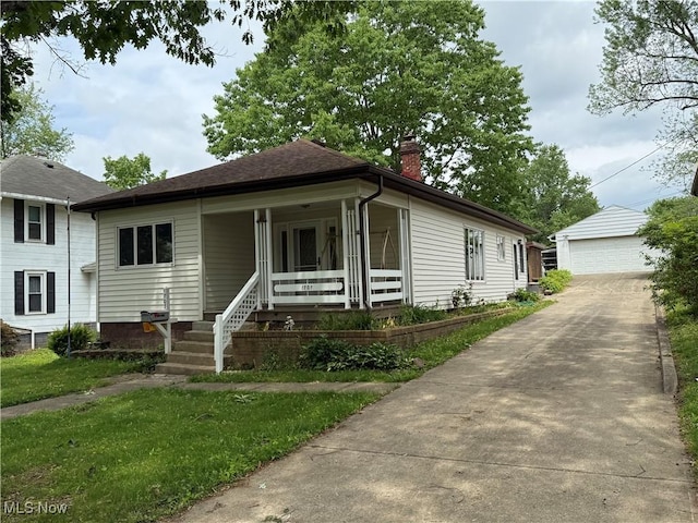 1707 Clairmont Ave, Cambridge, OH 43725 - view of front of house with a chimney, covered porch, a detached garage, and an outbuilding