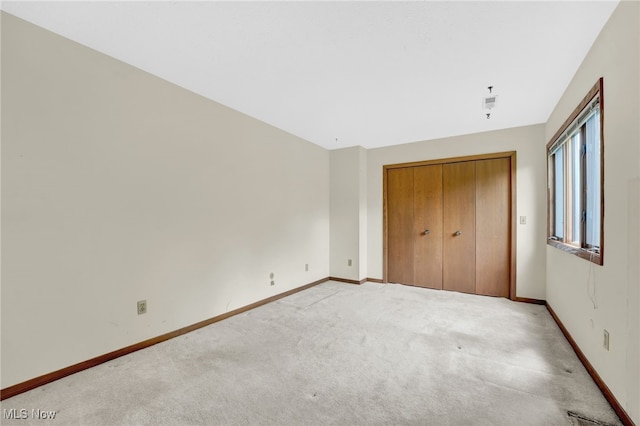 33 Brandon Pl, Rocky River, OH 44116 - unfurnished bedroom featuring light carpet, baseboards, and a closet