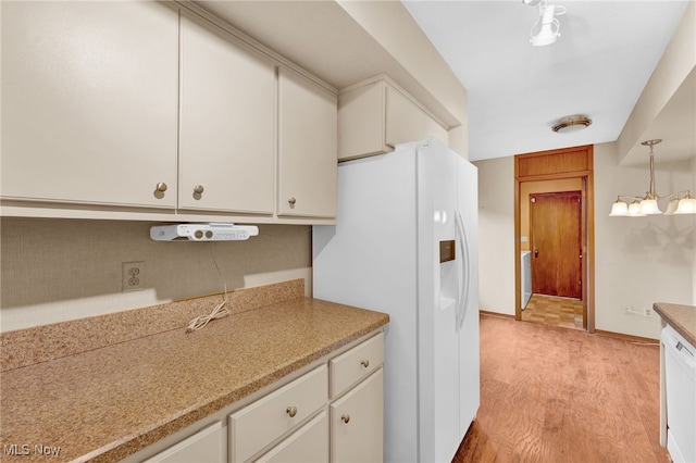 33 Brandon Pl, Rocky River, OH 44116 - kitchen with white appliances, light countertops, white cabinets, light wood-style floors, and pendant lighting