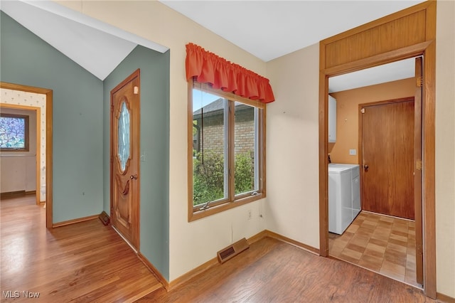 33 Brandon Pl, Rocky River, OH 44116 - entrance foyer featuring washer / clothes dryer, healthy amount of natural light, light wood finished floors, baseboards, and lofted ceiling