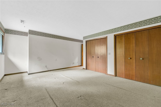33 Brandon Pl, Rocky River, OH 44116 - unfurnished bedroom featuring multiple closets, carpet flooring, and baseboards