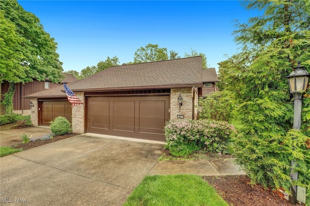 33 Brandon Pl, Rocky River, OH 44116 - view of front of house with driveway, brick siding, roof with shingles, and a garage