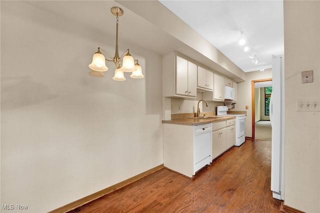 33 Brandon Pl, Rocky River, OH 44116 - kitchen with white appliances, a sink, white cabinets, wood finished floors, and a chandelier