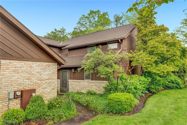 33 Brandon Pl, Rocky River, OH 44116 - view of front of property featuring brick siding, roof with shingles, and board and batten siding