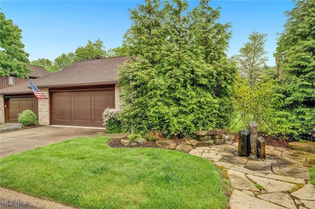 33 Brandon Pl, Rocky River, OH 44116 - view of property hidden behind natural elements with brick siding, concrete driveway, a garage, roof with shingles, and a front lawn