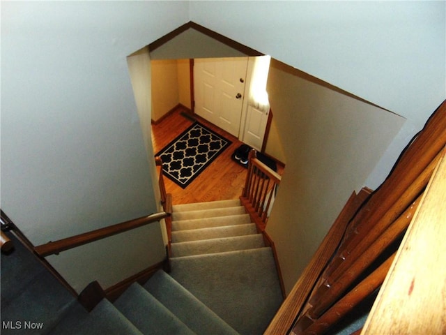 stairs featuring wood finished floors