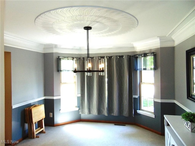 unfurnished room with crown molding, carpet, baseboards, and a chandelier