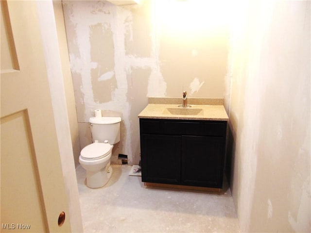 bathroom featuring toilet and vanity