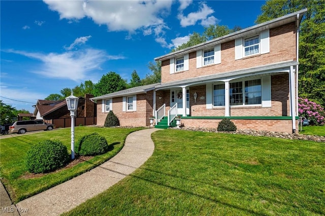 128 E Circle Dr, Weirton, WV 26062 - traditional home with covered porch, brick siding, and a front lawn