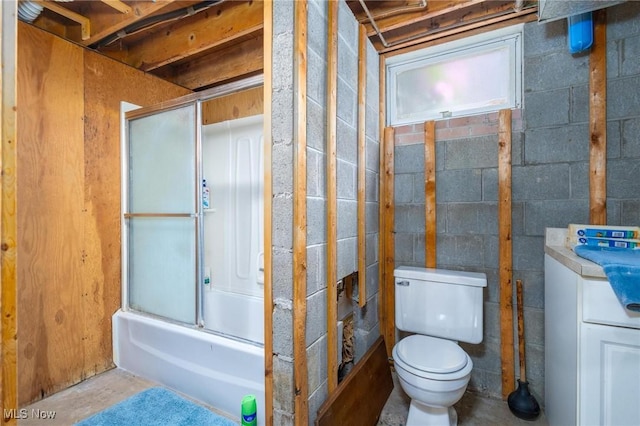 128 E Circle Dr, Weirton, WV 26062 - bathroom featuring toilet, enclosed tub / shower combo, concrete block wall, and concrete flooring
