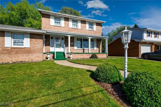 128 E Circle Dr, Weirton, WV 26062 - traditional-style house featuring brick siding, a front yard, a porch, and an attached garage