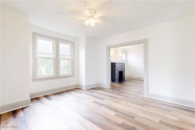 520 Lincoln Blvd, Steubenville, OH 43952 - unfurnished room with a ceiling fan, light wood-style flooring, a fireplace, and baseboards