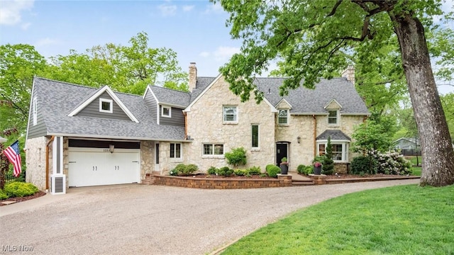 1251 Marwood Dr, Zanesville, OH 43701 - view of front of home featuring a chimney, stone siding, driveway, a garage, and a shingled roof