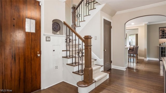 1251 Marwood Dr, Zanesville, OH 43701 - entrance foyer with arched walkways, wood finished floors, stairway, crown molding, and baseboards