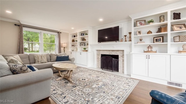 1251 Marwood Dr, Zanesville, OH 43701 - living area with crown molding, wood finished floors, a fireplace with flush hearth, recessed lighting, and built in features