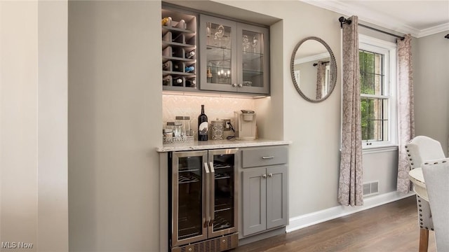 1251 Marwood Dr, Zanesville, OH 43701 - indoor dry bar with wine cooler, ornamental molding, baseboards, dark wood-style flooring, and backsplash